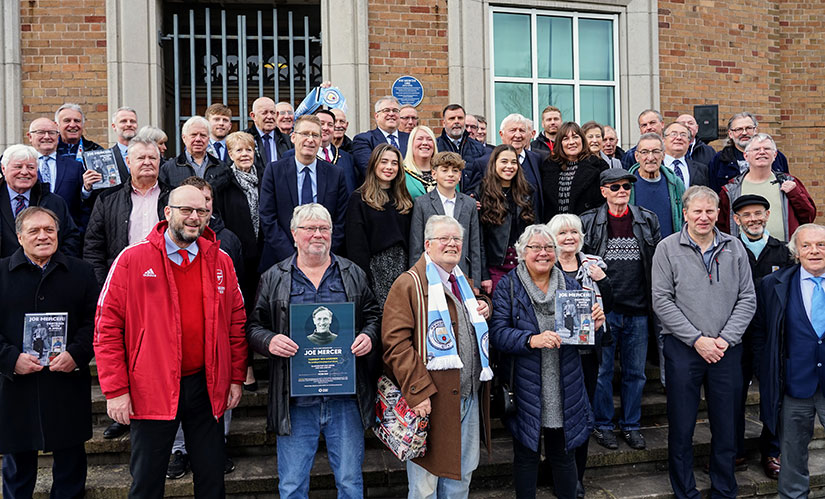 The attendees assembled in front of the new plaque